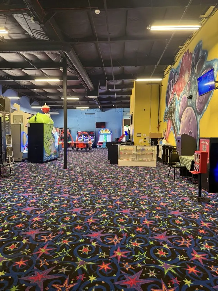 Arcade entertainment center interior with patterned carpet at SacTag.