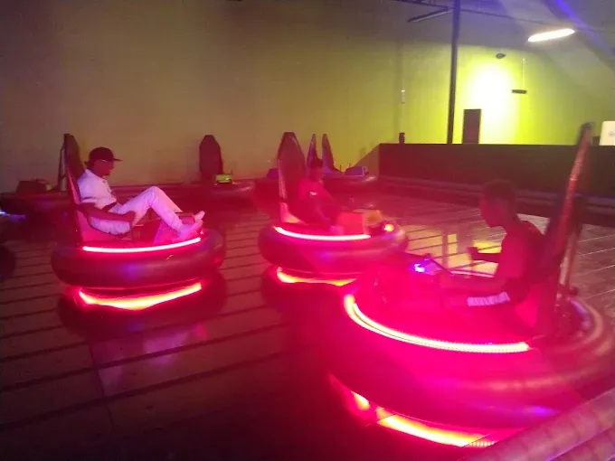 Indoor bumper cars with neon lights at SacTag.