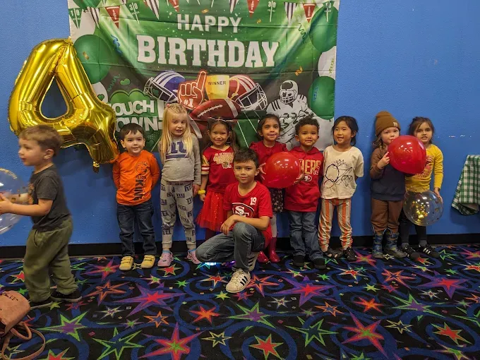 Children celebrating together at an indoor birthday party