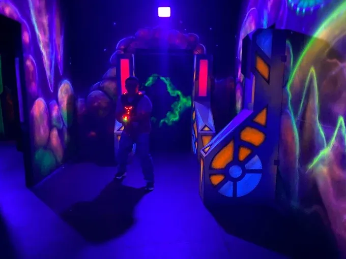 Two-story laser tag arena at SacTag Sacramento with neon lights and fog effects
