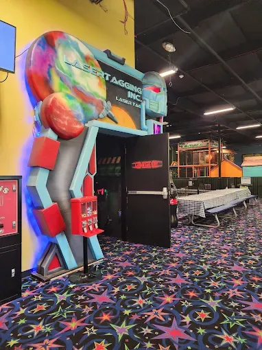 Space-themed arcade entrance with vending machines at the venue