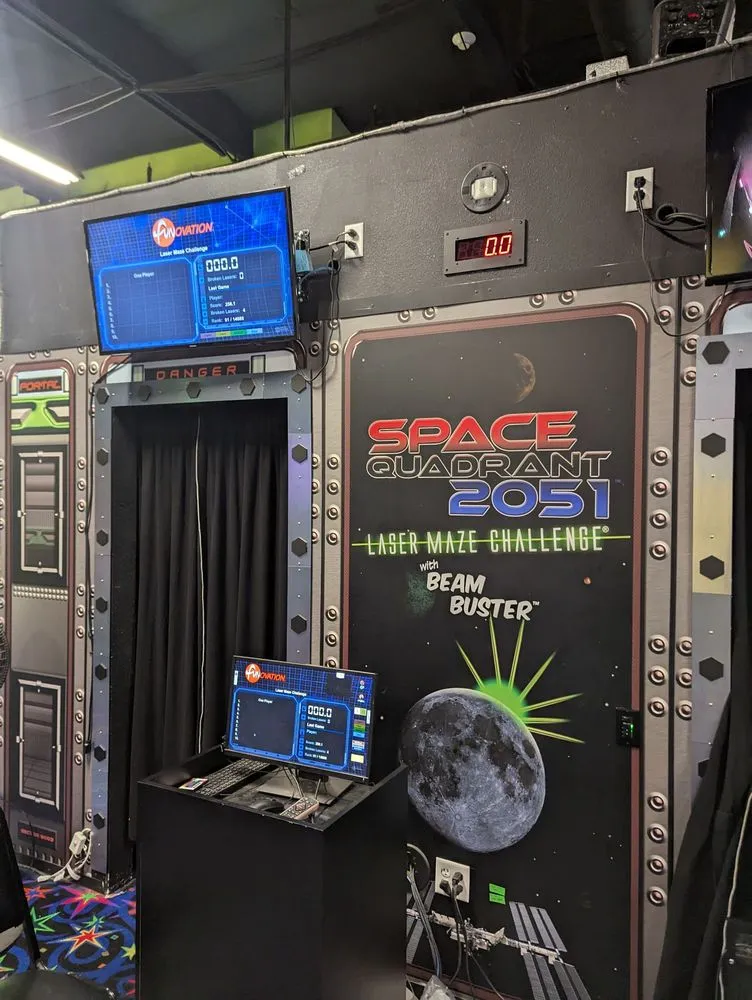 Neon-glowing laser maze platform with space-themed lighting